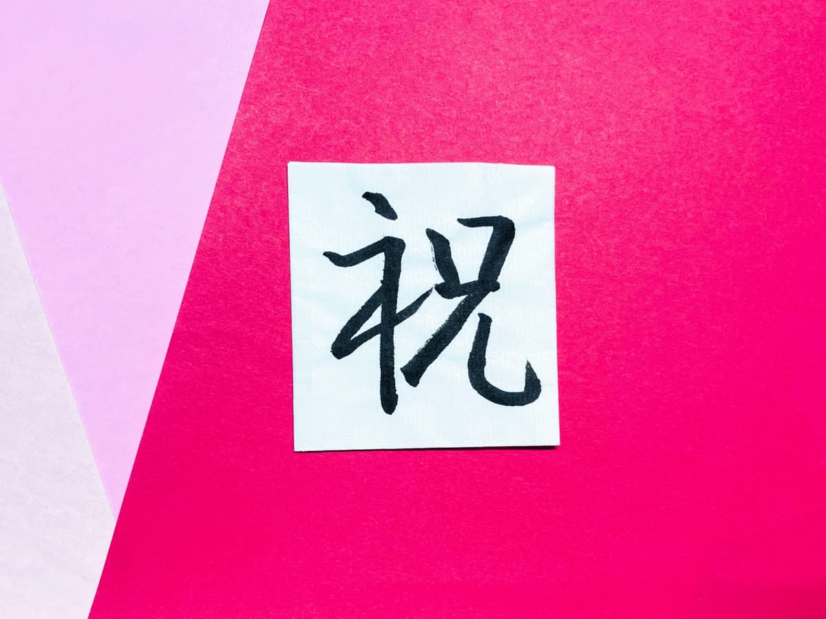 ピンクの背景に「祝」の書