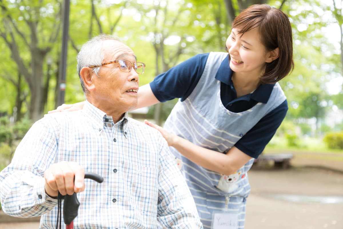 公園でお年寄りに寄り添う介護士