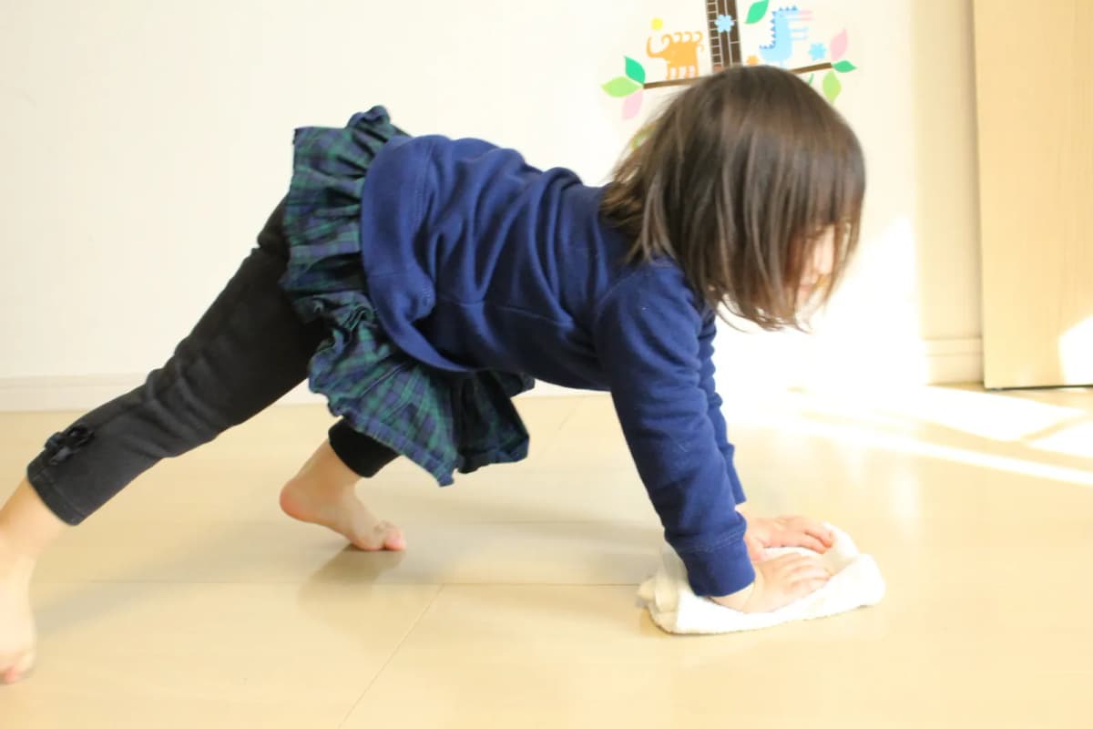 雑巾で拭き掃除をする子ども